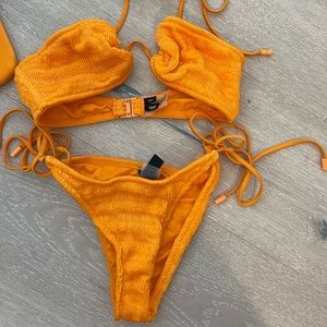 Orange textured bikini by TRIANGL with matching bikini bag.